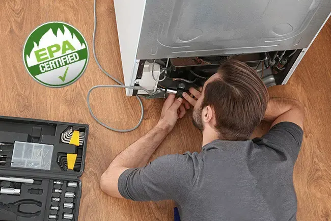 Appliance technician working on a refrigerator